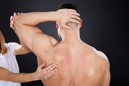 Close-up Of A Physiotherapist Giving Shoulder Massageの写真素材