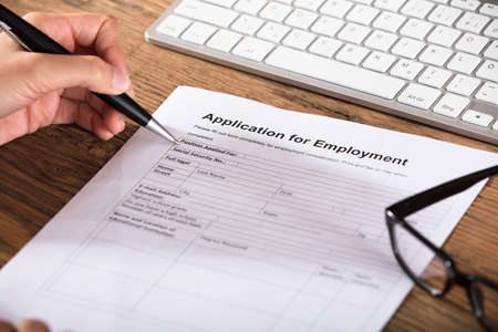 Close-up Of A Person Filling The Employment Application Formの写真素材