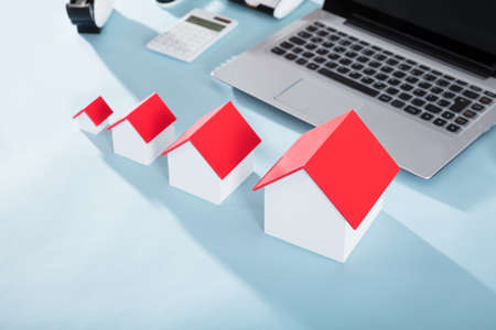 Different Size House Models With Red Roof On Office Deskの写真素材