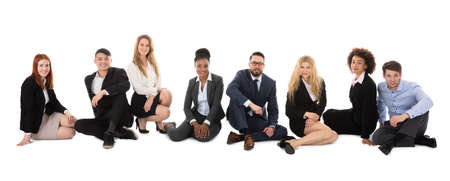 Group Of Happy Multiracial Businesspeople Sitting On White Backgroundの写真素材