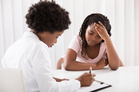 Portrait Of Female Doctor Comforting Depressed Patientのeditorial素材