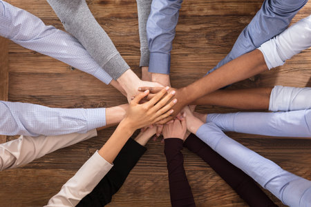 High Angle View Of Multiracial Businesspeople Stacking Their Hands