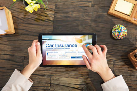 Businesswoman Filling The Car Insurance Form On Digital Tablet