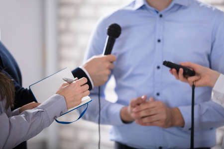A Businessman Answering Questions During The Press Conferenceの写真素材