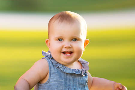Portrait Of A Smiling Cute Infant Baby Girlの写真素材
