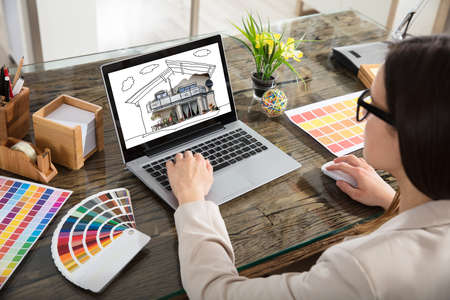 An Architect Working With Color Samples For Selection Using Laptopの写真素材