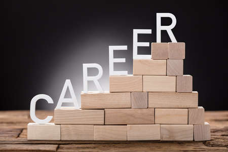 Closeup of career text on steps made of wooden blocks on tableの写真素材