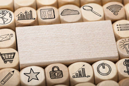 Full frame shot of wooden block surrounded by various computer iconsの写真素材