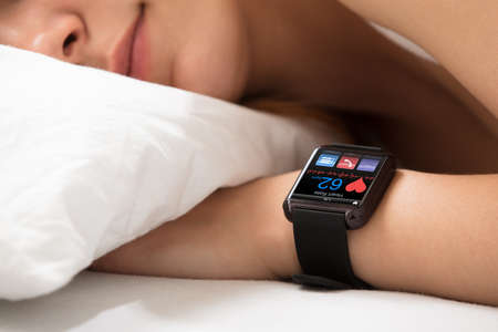 Smart Watch Showing Heartbeat Rate On Sleeping Woman's Hand