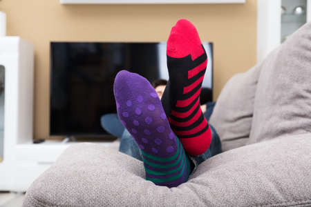 Close-up Of A Human Feet With Dotted And Striped Pattern Socksの写真素材