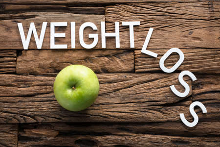 Closeup of white weight loss text on woodの写真素材