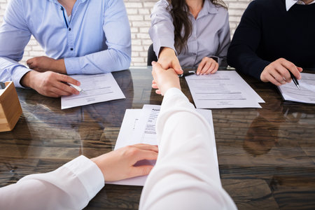 Close-up Of An Applicant Shaking Hand With Corporate Recruitment Officers In Officeのeditorial素材