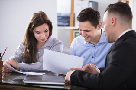 Couple Talking With Advisor During Meeting In Officeのeditorial素材