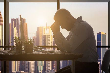 Young Businessman Suffering From Headache In Modern Officeのeditorial素材