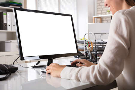 Young Businesswoman Working On Computer With Blank White Screen