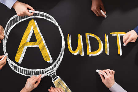 People Drawing Audit And Fraud Investigation Concept On Blackboard