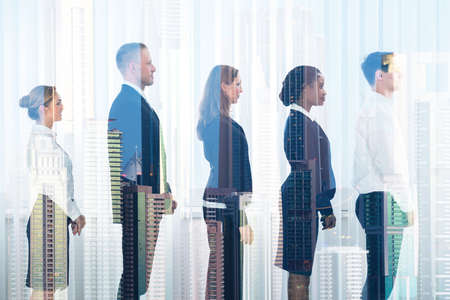 Side view of multiethnic business people standing in row seen through glass
