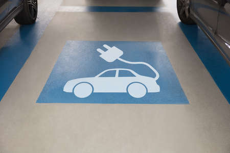 High angle view of electric car sign in parking areaの写真素材