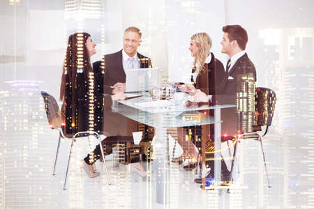 Double exposure of happy business people in meeting on city background