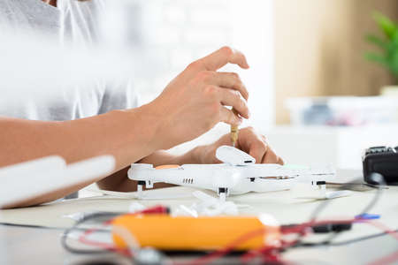 Close-up Of A Man Repairing Quadrocopter Drone