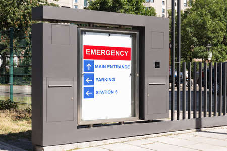 Board with emergency sign at hospital main entranceの写真素材