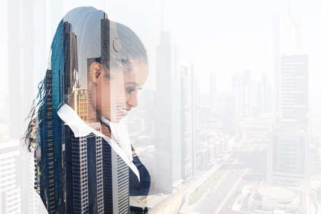 Digital composite image of young businesswoman smiling over city background