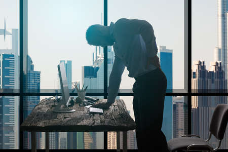 Young Businessman Suffering From Backpain In Modern Office