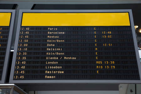 Low angle view of flight information board in airportの写真素材