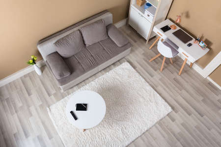 Overhead View Of Modern Living Room With Computer Desk And Sofaの写真素材