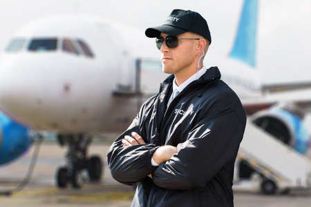 Close-up Of A Young Male Security Guard With Arms Crossed
