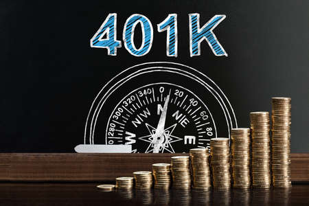 401k Pension Plan On Blackboard Behind Stacked Coinsの写真素材