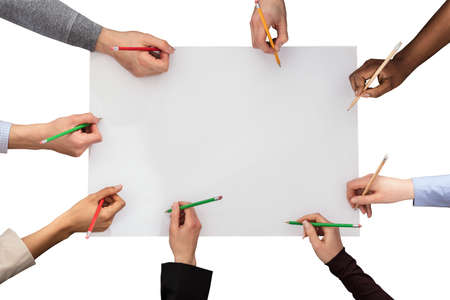 Elevated Of Hands With Pencil On White Paper Against White Backgroundの写真素材