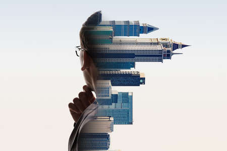 Digital Composite Of City And Contemplating Businessman Portrait