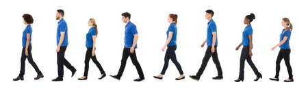 Group Of Janitors Walking In A Row Over White Backgroundの写真素材