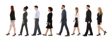 Businesspeople Walking In A Line Over White Background