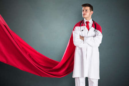 Portrait Of Young Superhero Doctor In Red Capeの写真素材
