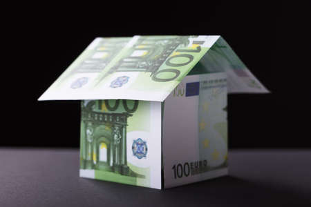 Close-up Of A House Made Up Of Banknote On Black Backgroundの写真素材