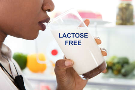Woman Drinking Glass Of Milk With Lactose Free Textの写真素材