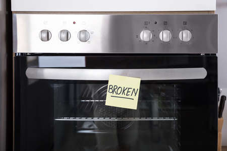 Close-up Of A Oven With Sticky Notes Showing Broken Text