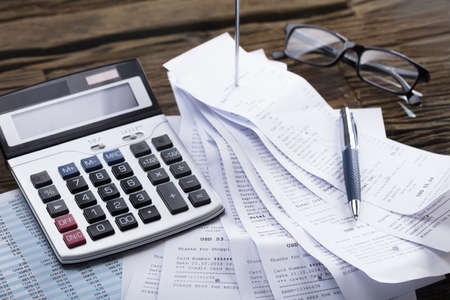 Elevated View Of Calculator And Pen On Receipt In Officeの写真素材