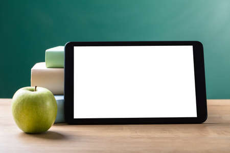 Close-up Of Green Apple And Digital Tablet With Blank White Screen