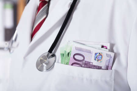 Close-up Of A Doctor's Pocket With Banknoteの写真素材