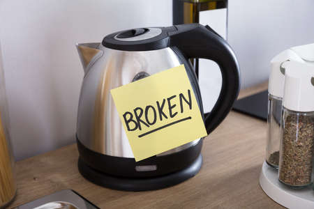 Close-up Of A Tea Flask With Adhesive Notes Showing Broken Text
