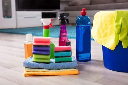 Blue Colored Bucket With House Cleaning Products On Hardwood Floor At Home