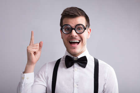 Excited Man Having An Idea Against Grey Background