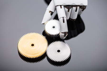 Elevated View Of A Robot's Hand Holding Metal Gear