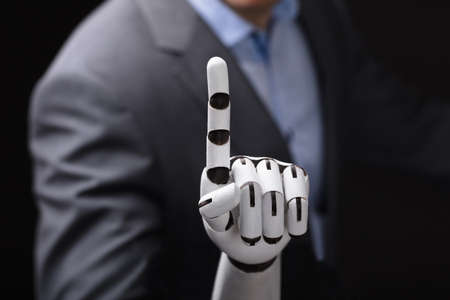Close-up Of A Businessperson With Robotic Arm Touching Screenの写真素材