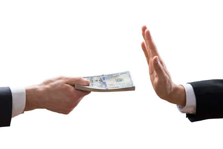 Businessperson's Hand Refusing To Take Bribe From Partner On White Background
