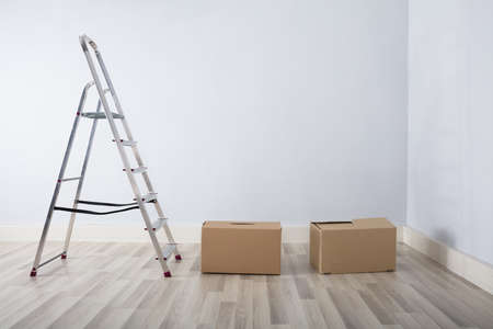 Stack Of Boxes In New House With Ladderの写真素材