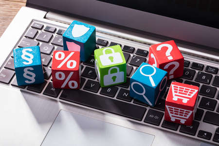 Elevated View Of Social Symbols On Wooden Block Over The Laptop Keypad